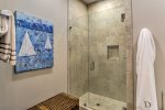 Easy access walk-in shower and nice beachy decor in the master bath